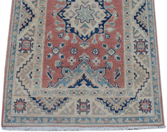 Handmade Afghan Kazakh runner rug featuring traditional geometric motifs in red, blue, and cream.