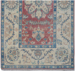Handmade Afghan Kazakh runner rug featuring traditional geometric motifs in red, blue, and cream.
