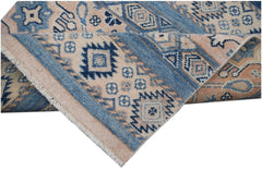 A handmade Afghan Kazakh runner featuring geometric patterns in shades of blue and beige.