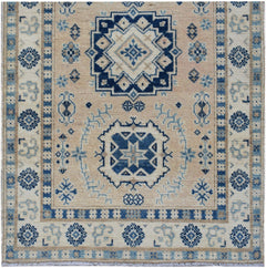 Handmade Afghan Kazakh runner featuring traditional geometric patterns in blue and beige wool.