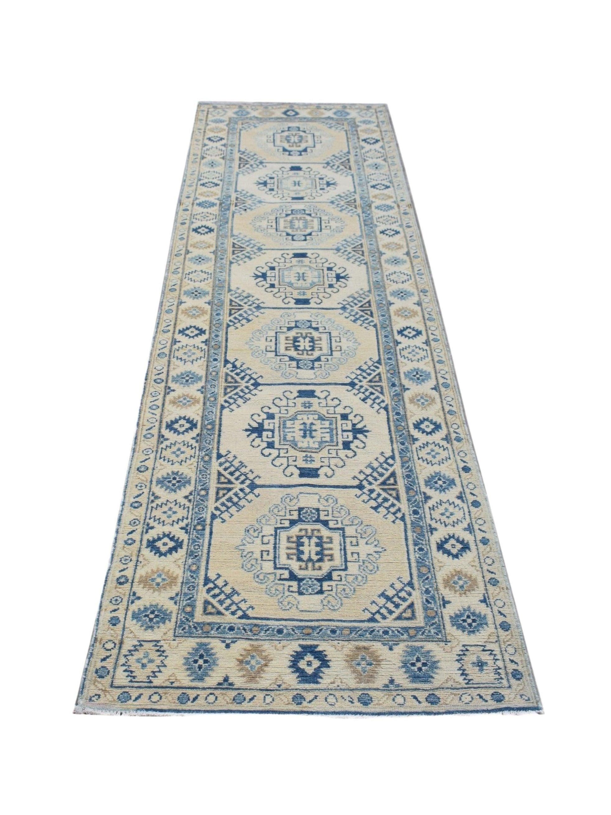A handmade Afghan Kazakh runner rug featuring traditional geometric patterns in blue and cream.