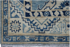 Handmade Afghan Kazakh runner rug featuring a geometric blue and beige pattern with fringe.