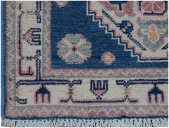 A handmade Afghan Kazakh runner featuring traditional geometric motifs in blue, pink, and cream.