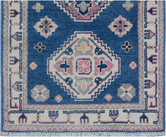 Handmade Afghan Kazakh runner rug featuring traditional geometric motifs in blue, pink, and cream.