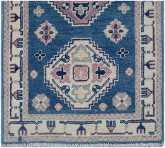 Handmade Afghan Kazakh runner rug featuring traditional geometric motifs in blue and pink tones.