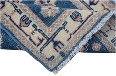 A handmade Afghan Kazakh runner featuring traditional blue and cream geometric patterns.