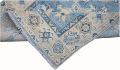 A handmade Afghan Kazakh runner featuring traditional geometric patterns in blue and cream wool.