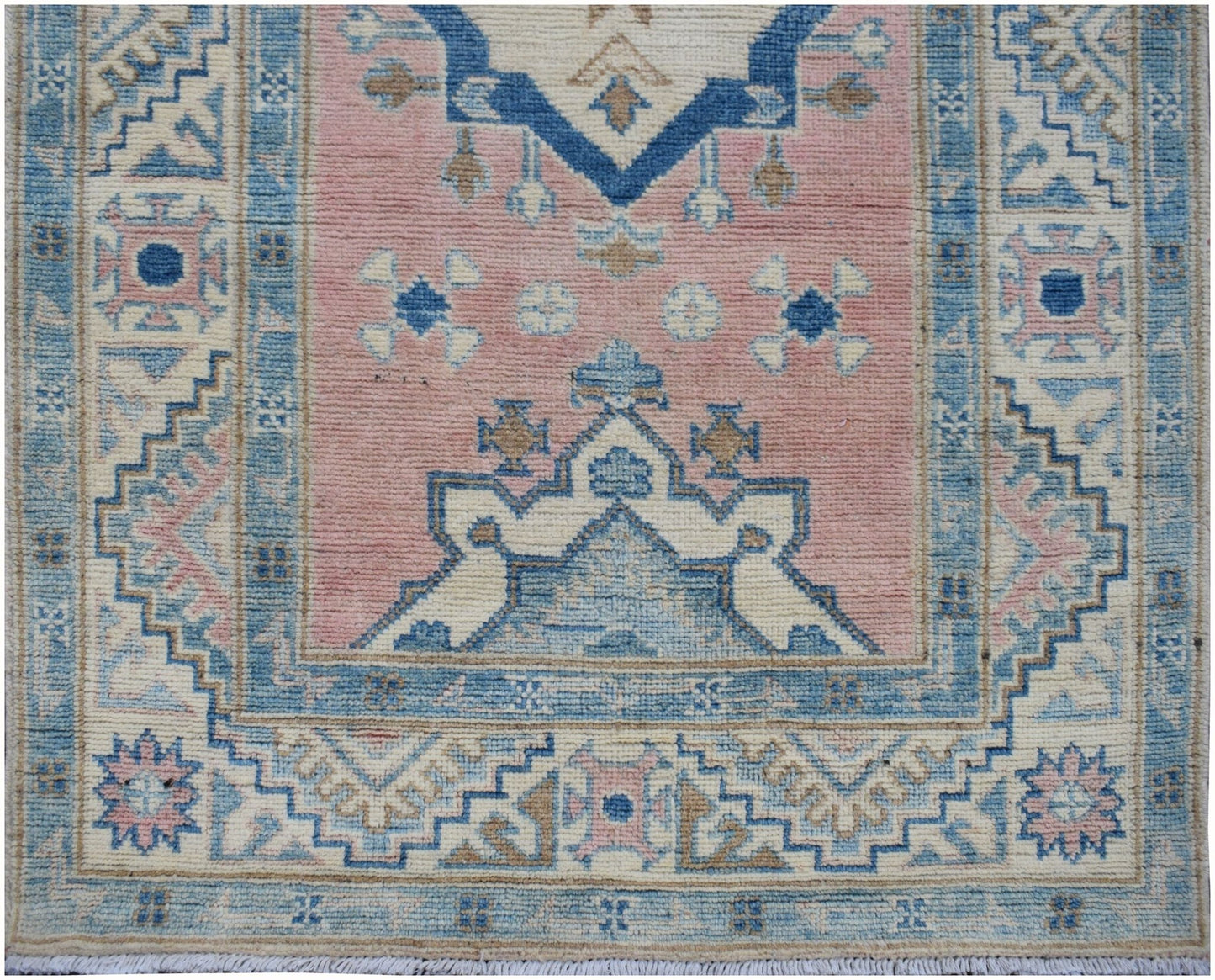 Handmade Afghan Kazakh runner featuring traditional geometric patterns in pink, blue, and cream.
