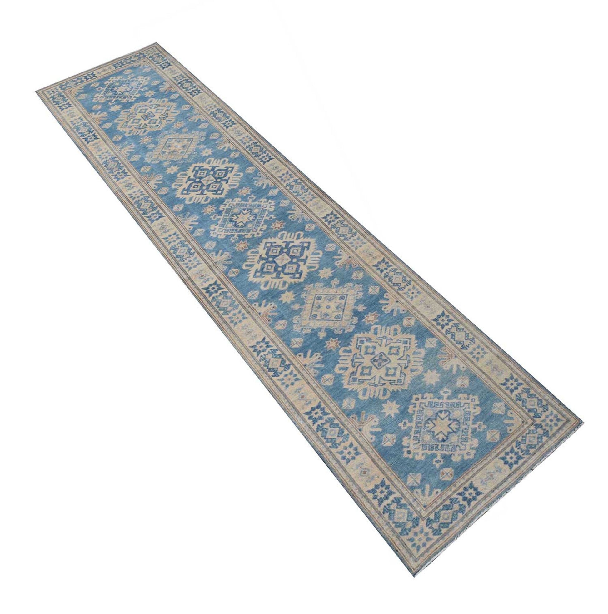 A handmade Afghan Kazakh runner rug featuring a repeating geometric pattern in blue and beige.