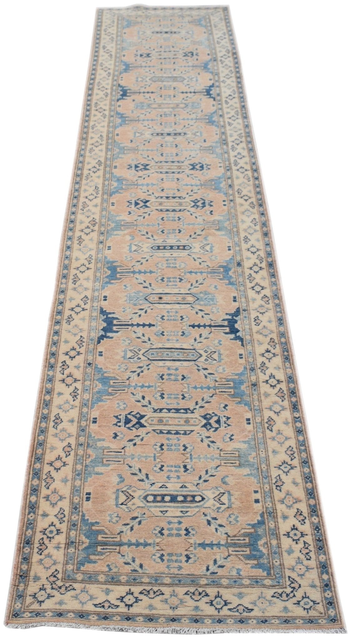 A handmade Afghan Kazakh runner rug featuring a traditional geometric pattern in beige and blue.