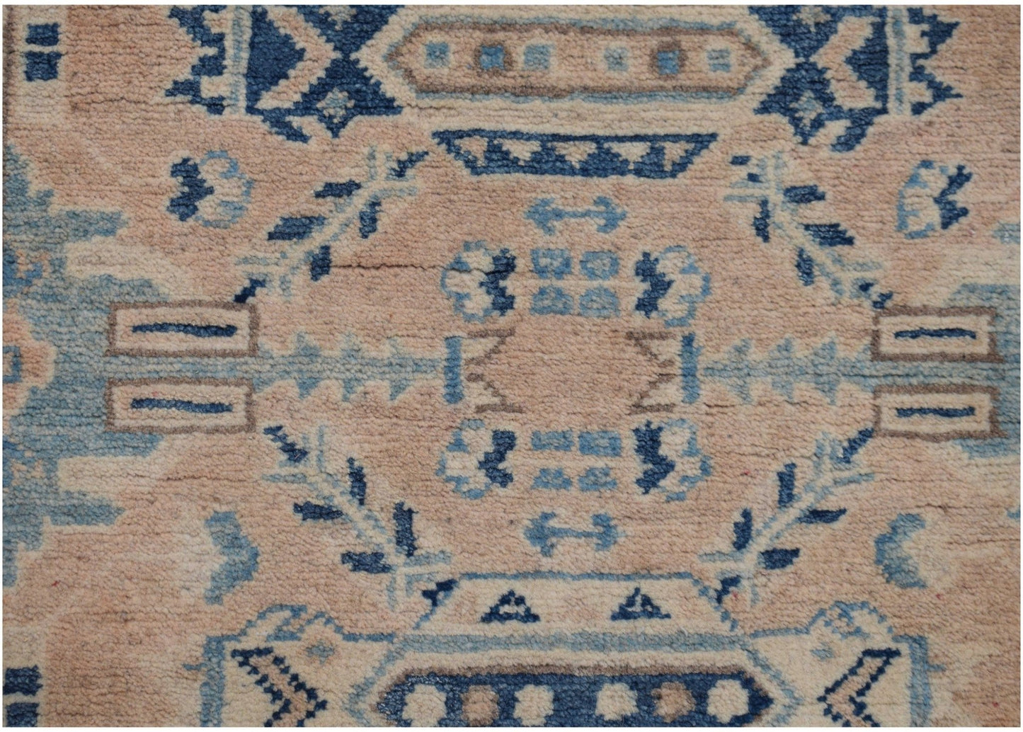 Handmade Afghan Kazakh runner rug featuring a geometric pattern in shades of beige and blue.