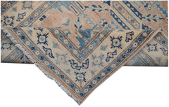 Handmade Afghan Kazakh runner rug featuring a beige field with blue and grey geometric patterns.