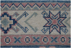 A close-up of an Afghan Kazakh runner featuring traditional geometric star and border motifs.