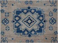 Handmade Afghan Kazakh runner rug featuring a geometric blue and beige medallion pattern.