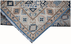 Handmade Afghan Kazakh runner rug featuring a geometric pattern in beige, blue, and grey tones.