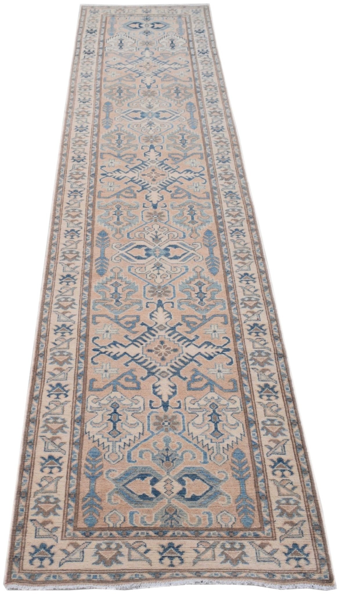 A handmade Afghan Kazakh runner rug featuring a beige background with blue and grey geometric motifs.