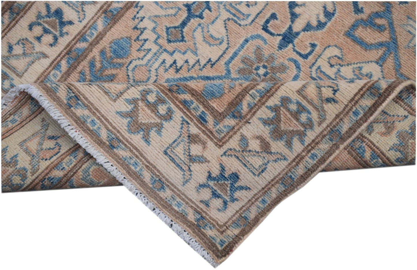 An Afghan Kazakh runner rug featuring a geometric pattern in shades of beige and blue.
