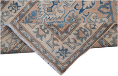 An Afghan Kazakh runner rug featuring a geometric pattern in shades of beige and blue.