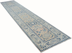 An Afghan Kazakh runner rug featuring a traditional blue and beige floral pattern.