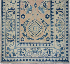 Handmade Afghan Kazakh runner featuring a central floral medallion in blue and beige tones.