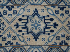 Handmade Afghan Kazakh runner rug featuring a central blue geometric medallion on a beige field.