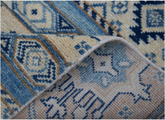 A handmade Afghan Kazakh runner rug featuring geometric patterns in shades of blue and beige.