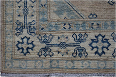 Handmade Afghan Kazakh runner featuring a geometric blue and beige wool pattern.
