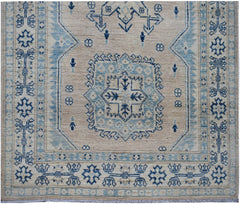 Handmade Afghan Kazakh runner rug featuring a geometric blue and beige pattern.