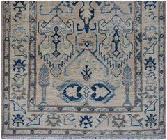 Handmade Afghan Kazakh runner rug featuring a beige field with blue and grey geometric patterns.