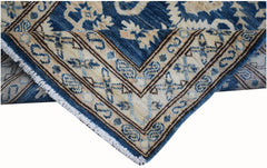 A handmade Afghan Kazakh runner featuring a blue and beige geometric pattern with fringe edges.