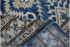 A handmade Afghan Kazakh runner featuring a traditional blue and beige geometric pattern.