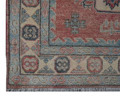 Handmade Afghan Kazakh runner featuring traditional geometric motifs in red, blue, and cream wool.