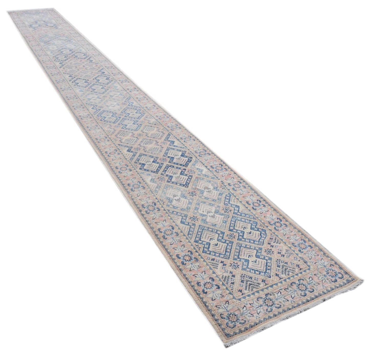A long, handmade Afghan Kazakh runner rug featuring a geometric pattern in blue, beige, and grey.
