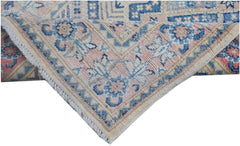 A handmade Afghan Kazakh runner featuring a traditional floral pattern in blue, pink, and beige.