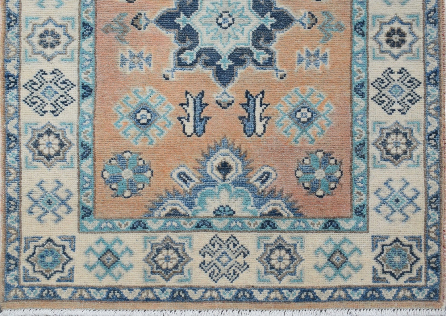 Handmade Afghan Kazakh runner featuring a geometric floral pattern in blue, beige, and grey.