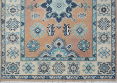 Handmade Afghan Kazakh runner featuring a geometric floral pattern in blue, beige, and grey.