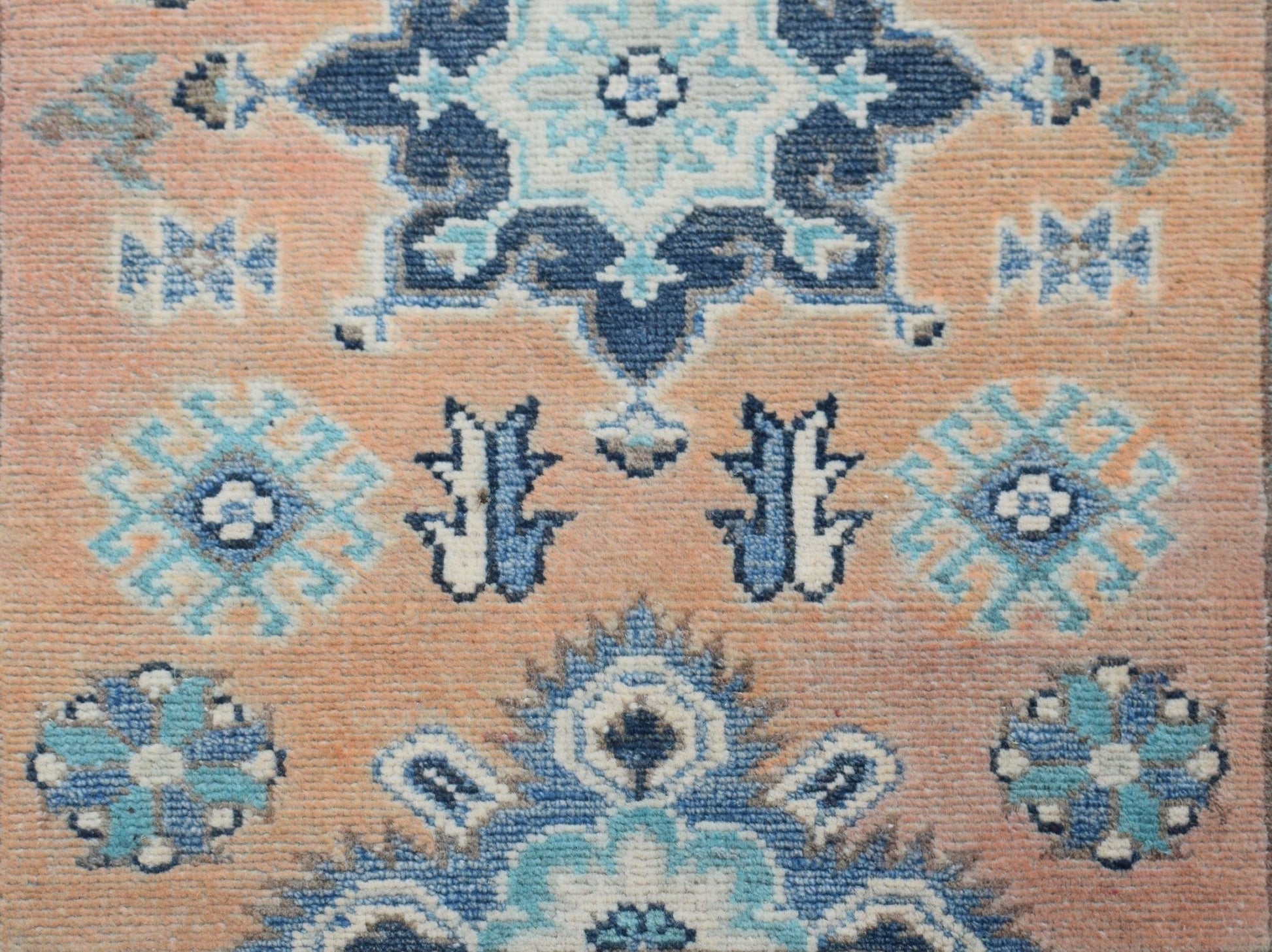Handmade Afghan Kazakh runner featuring a geometric floral pattern in shades of blue and beige.