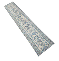A handmade Afghan Kazakh runner rug featuring a traditional blue and grey pattern on a beige base.