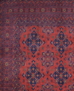 Handmade Afghan Khal Mohammadi rug featuring a deep red field with blue geometric floral motifs.