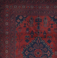 Handmade Afghan Khal Mohammadi rug featuring deep red tones and intricate geometric patterns.