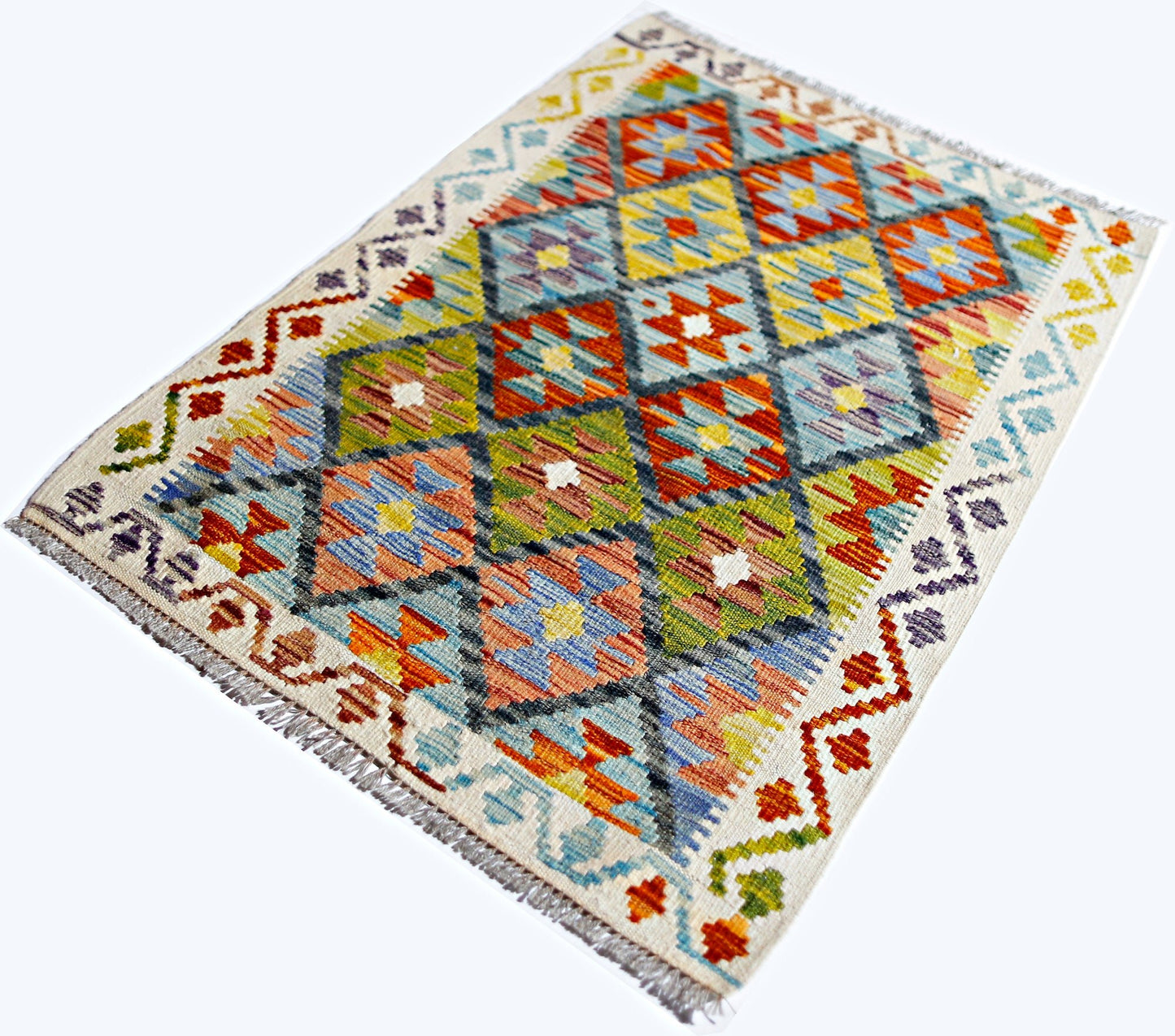 Handwoven Afghan Maimana kilim featuring a colorful geometric diamond pattern on a cream background.