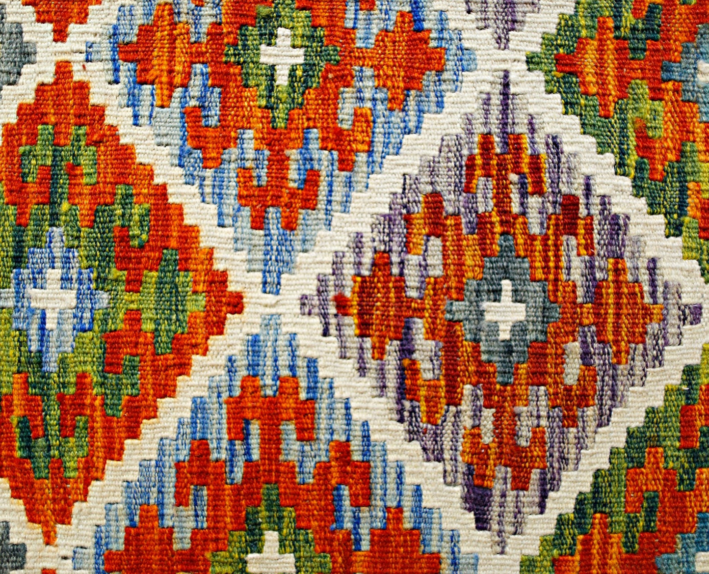 Handwoven Afghan Maimana kilim featuring a vibrant geometric diamond pattern in wool.