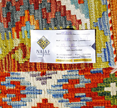 A handwoven Afghan Maimana kilim featuring a vibrant geometric pattern in wool.