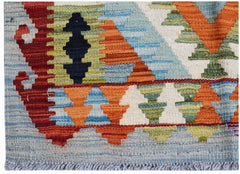 A handwoven Afghan Maimana kilim featuring a geometric pattern in vibrant orange, blue, and green.