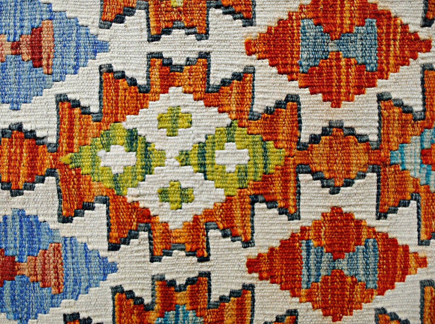 Handwoven Afghan Maimana kilim featuring a geometric pattern in orange, blue, and green wool.