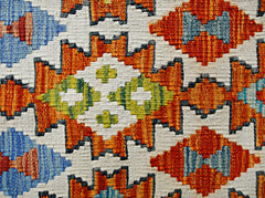 Handwoven Afghan Maimana kilim featuring a geometric pattern in orange, blue, and green wool.