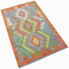 Handwoven Afghan Maimana kilim rug featuring a vibrant geometric diamond pattern in wool.