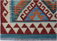 Handwoven Afghan Maimana kilim featuring a geometric pattern in red, blue, and orange wool.