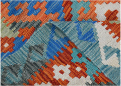 A close-up of a handmade Afghan Maimana kilim featuring vibrant geometric patterns in wool.