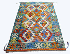 A rectangular Afghan Maimana kilim rug featuring a vibrant, multi-colored geometric diamond pattern.